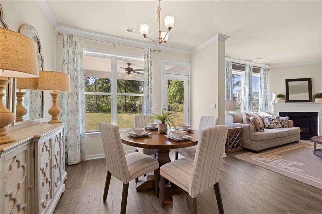 13632 Whitman Lane Covington, GA 30014 - Photo 28 of 53 a dining room with furniture a chandelier and wooden floor