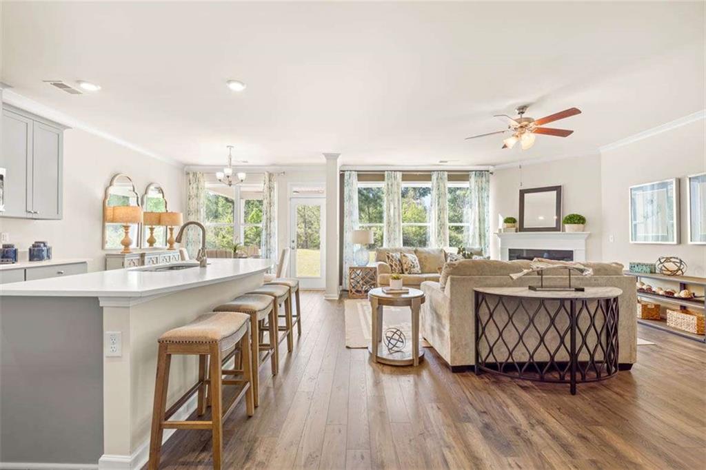 13632 Whitman Lane Covington, GA 30014 - Photo 9 of 53 a living room with furniture a wooden floor and a sink
