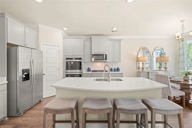 a kitchen with stainless steel appliances a microwave a sink a stove and refrigerator