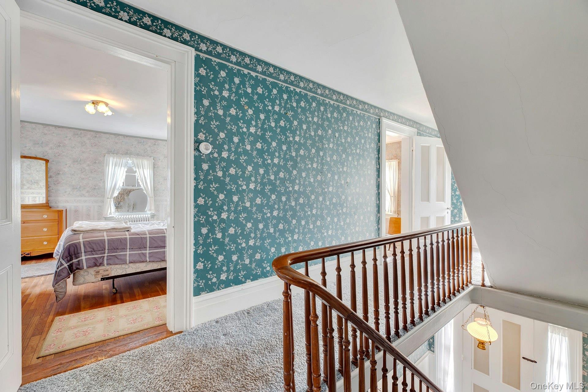 1760 Albertson Lane Greenport, NY 11944 - Photo 12 of 40 Hallway featuring wallpapered walls and baseboards