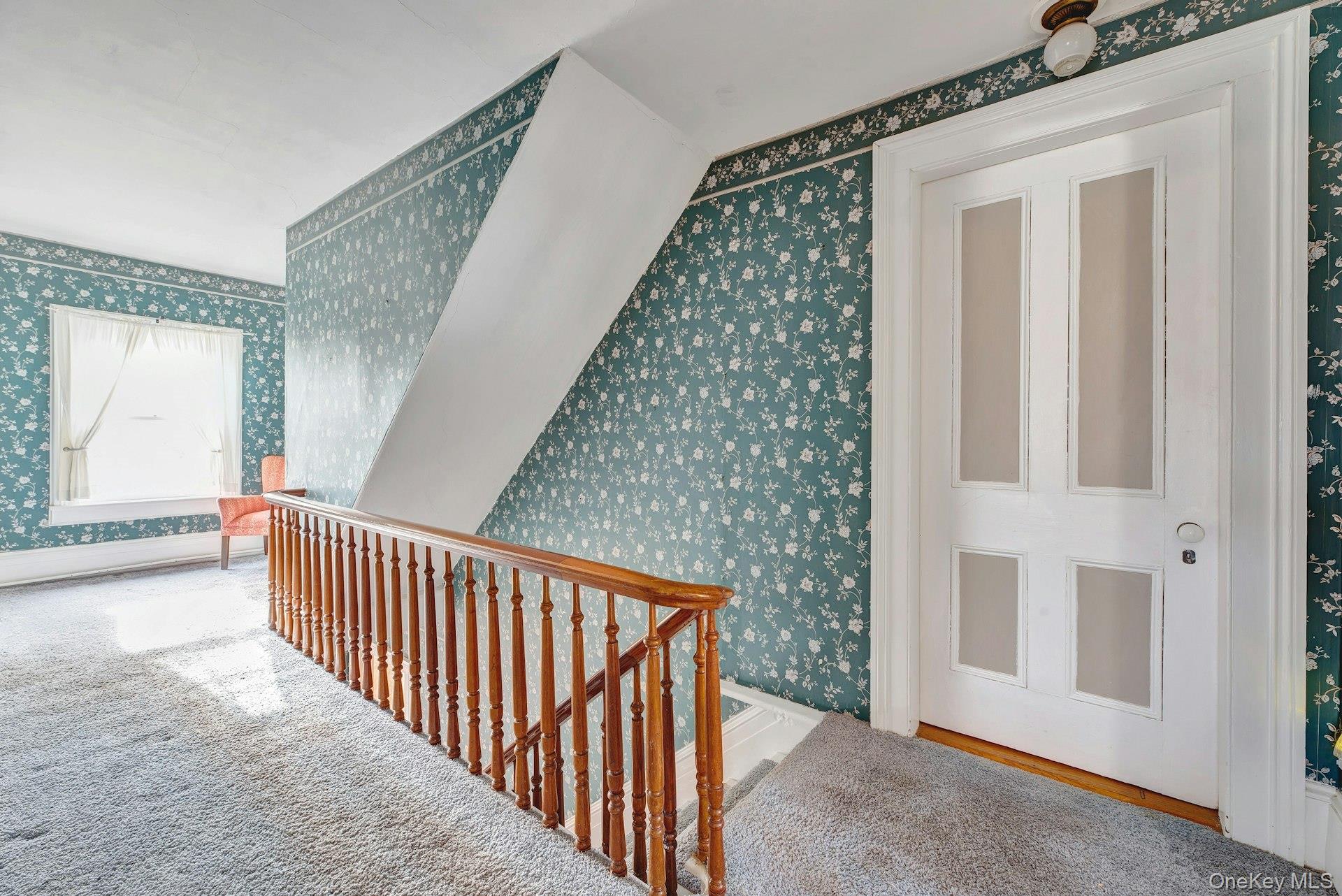 1760 Albertson Lane Greenport, NY 11944 - Photo 13 of 40 Hallway with an upstairs landing and wallpapered walls