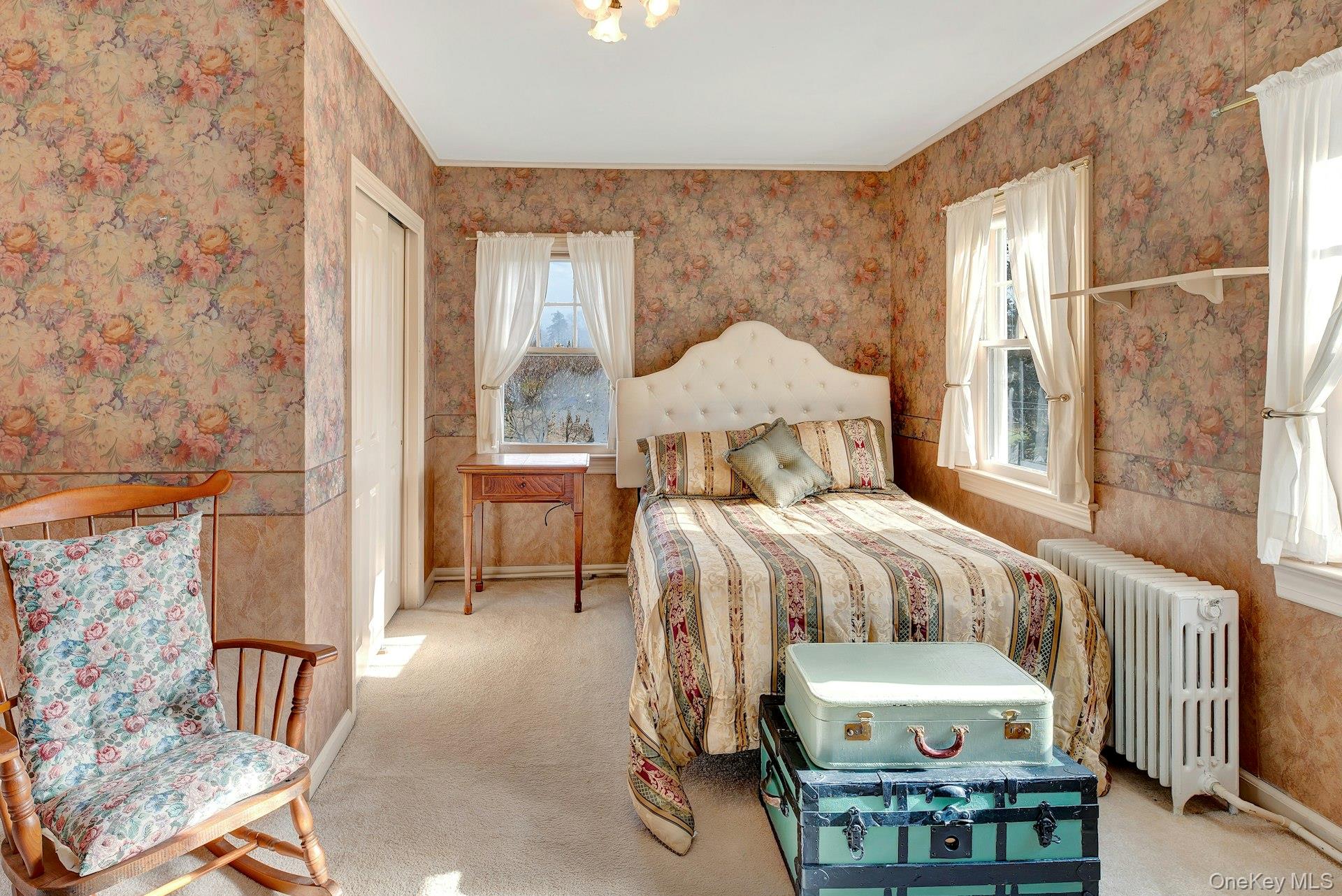 1760 Albertson Lane Greenport, NY 11944 - Photo 15 of 40 Carpeted bedroom with radiator heating unit, wallpapered walls, and a closet