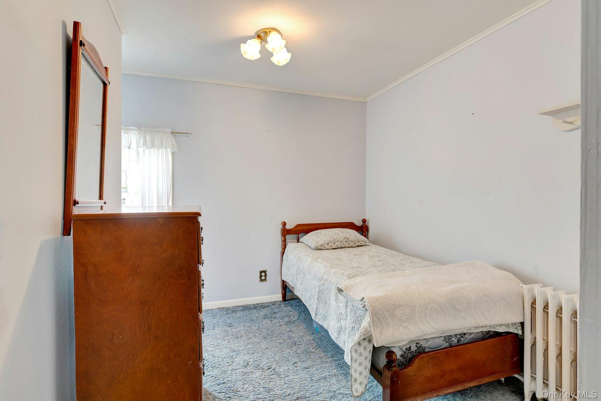 1760 Albertson Lane Greenport, NY 11944 - Photo 17 of 40 Bedroom featuring radiator, carpet floors, and ornamental molding