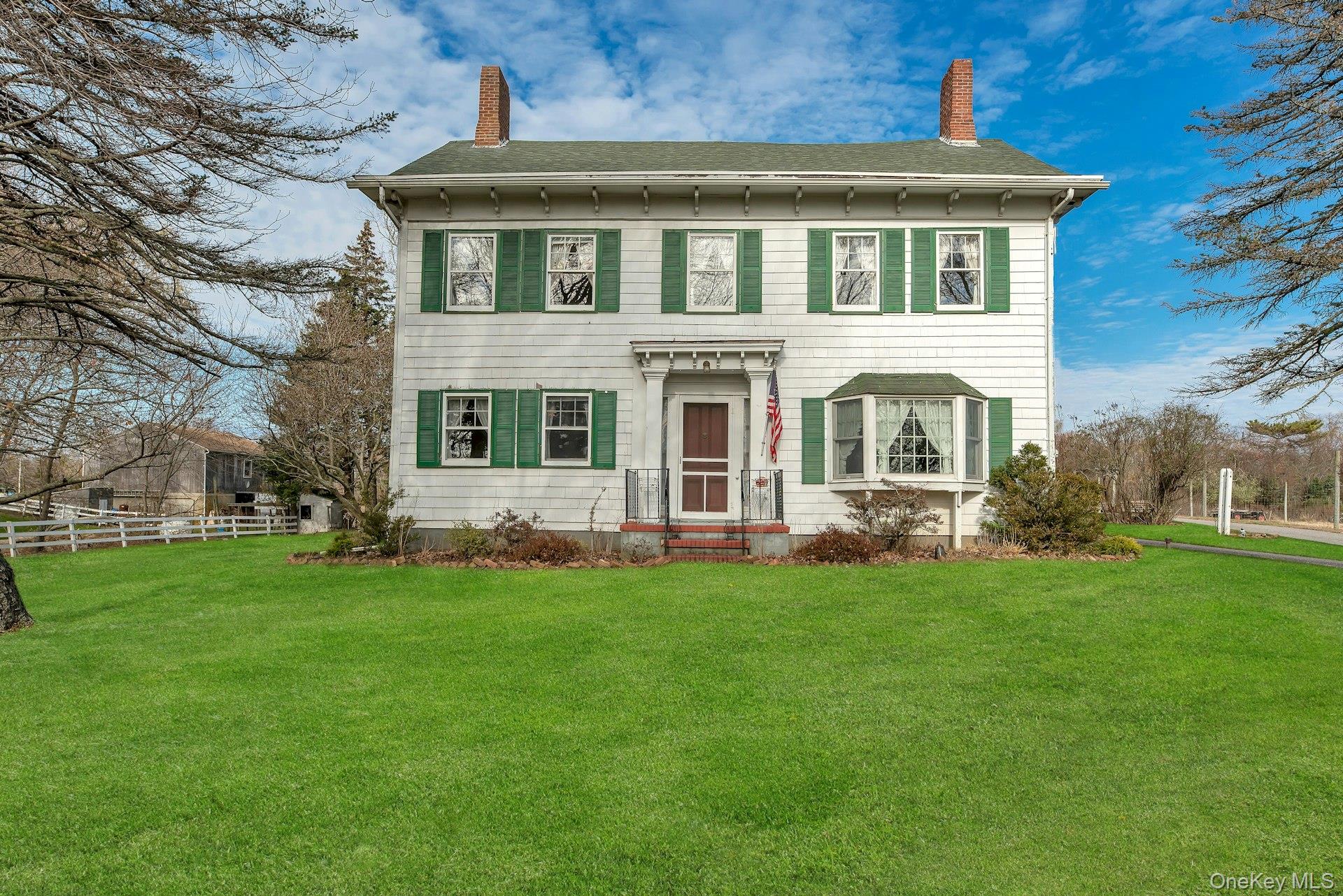 1760 Albertson Lane Greenport, NY 11944 - Photo 2 of 40 Italianate-style house with a chimney, roof with shingles, and entry steps