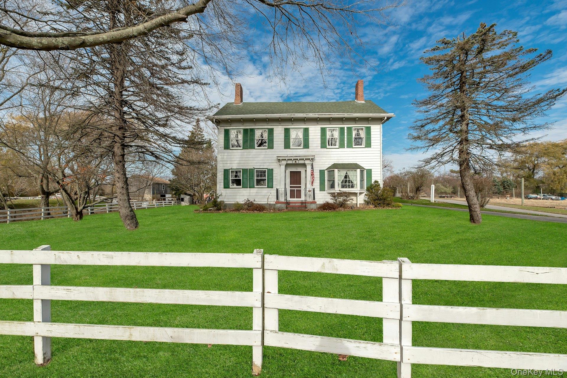 1760 Albertson Lane Greenport, NY 11944 - Photo 34 of 40 View of front of home with a chimney and a fenced front yard