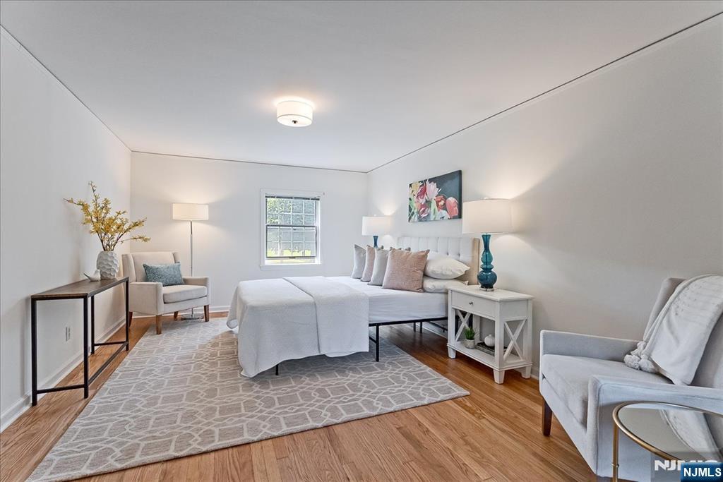 687 Grove Street Montclair, NJ 07043 - Photo 9 of 18 a bedroom with a bed and wooden floor