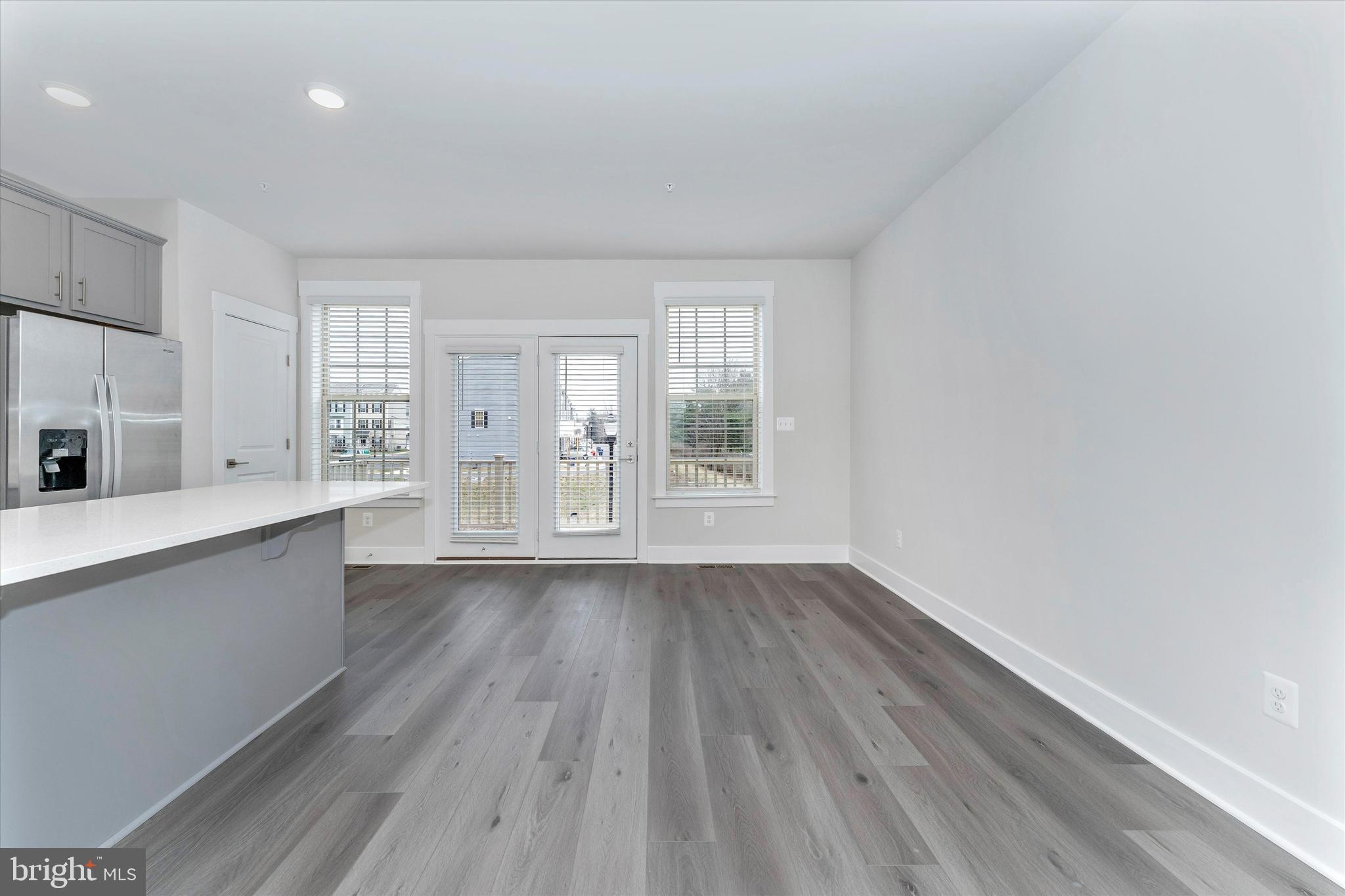 2923 Osprey Way Frederick, MD 21701 - Photo 11 of 42 an empty room with wooden floor and windows