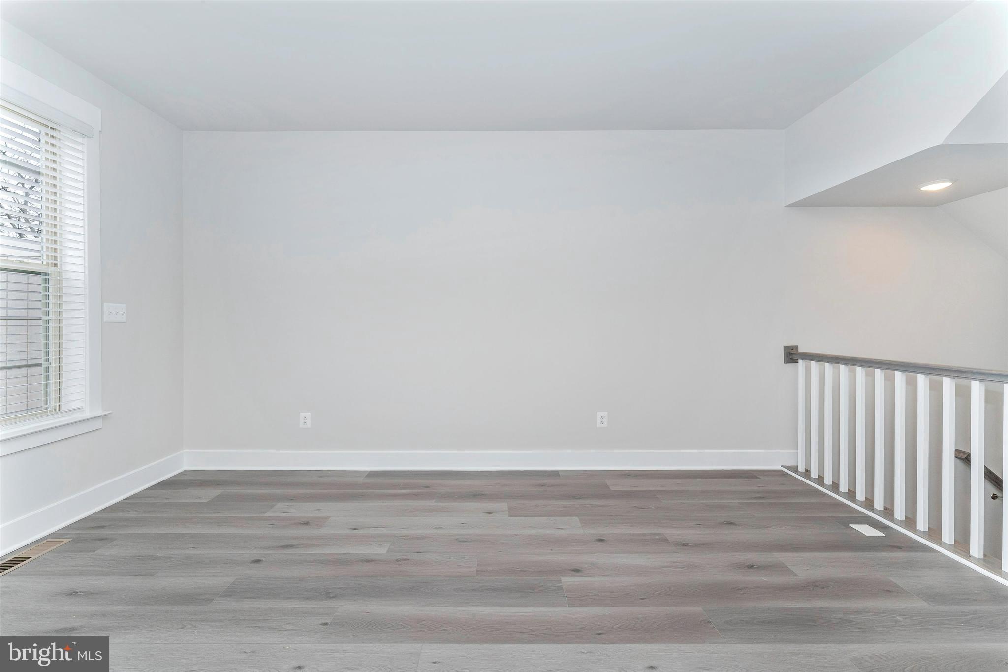 2923 Osprey Way Frederick, MD 21701 - Photo 15 of 42 a view of an empty room with wooden floor and a window