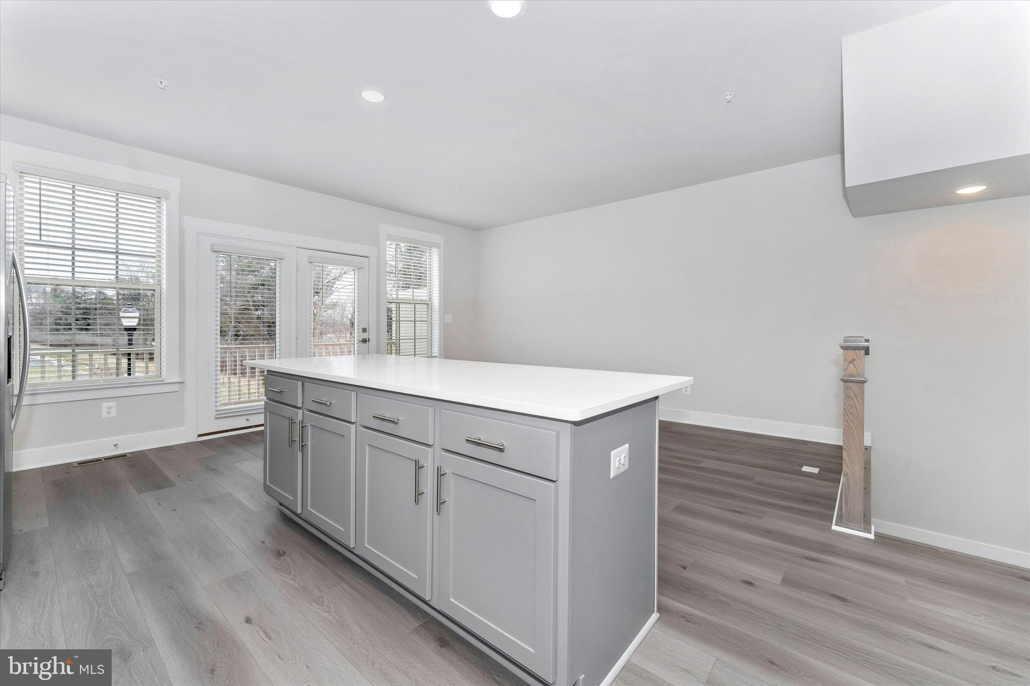 2923 Osprey Way Frederick, MD 21701 - Photo 20 of 42 a kitchen with granite countertop white cabinets and wooden floor