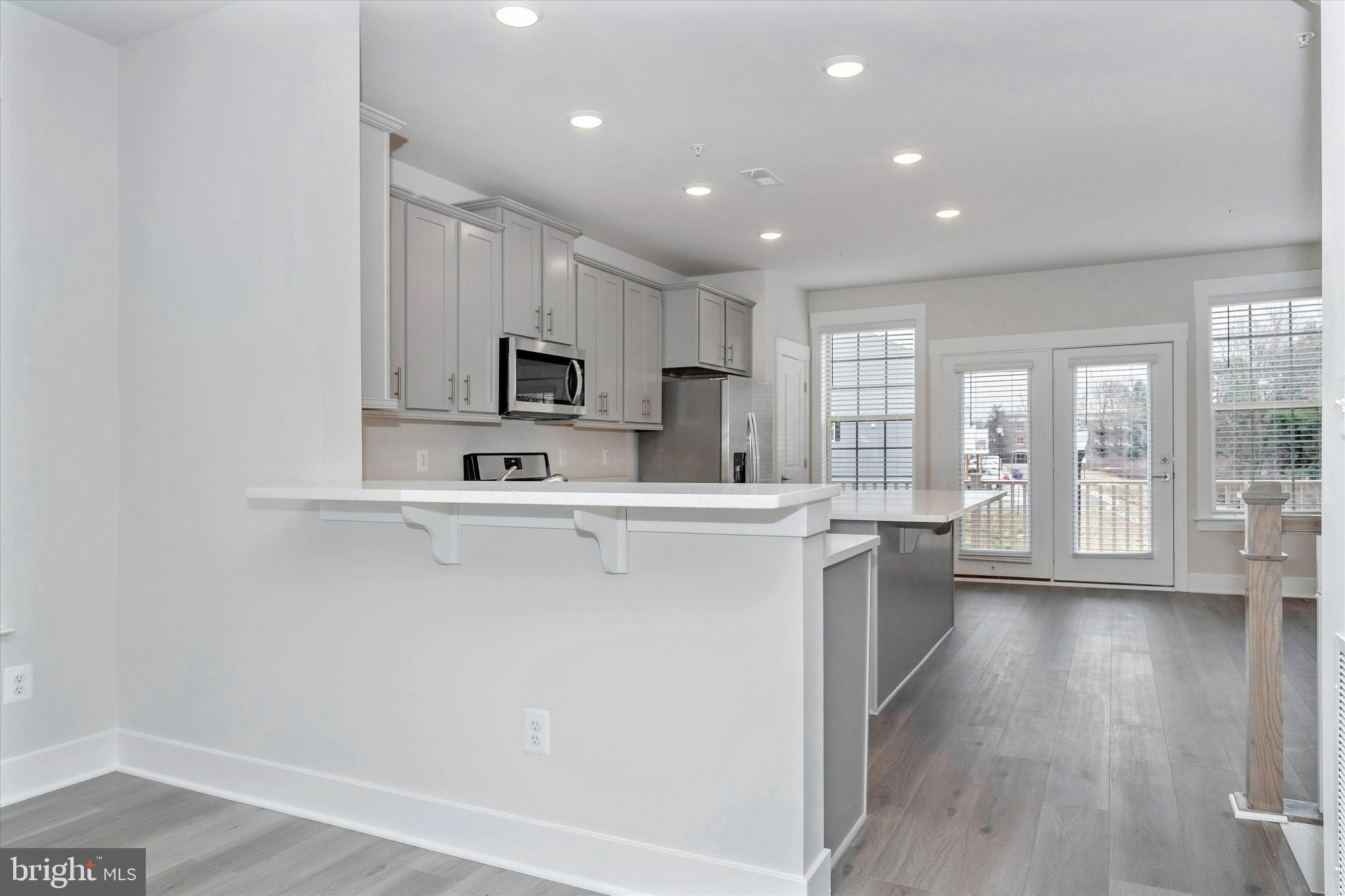 2923 Osprey Way Frederick, MD 21701 - Photo 28 of 42 a kitchen with stainless steel appliances granite countertop a stove a sink and a refrigerator