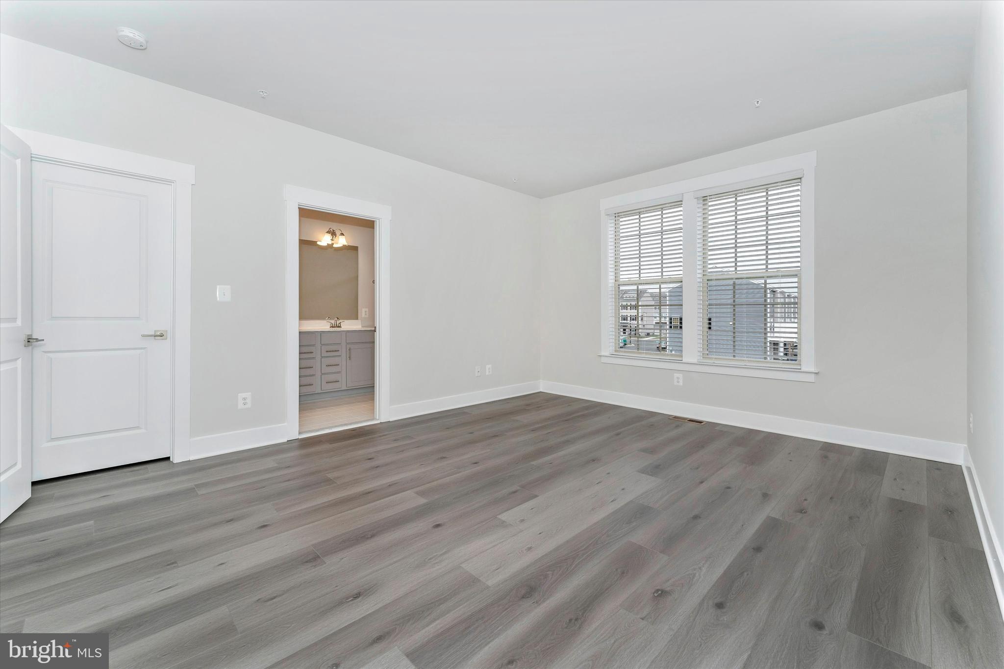 2923 Osprey Way Frederick, MD 21701 - Photo 31 of 42 a view of an empty room with wooden floor and a window