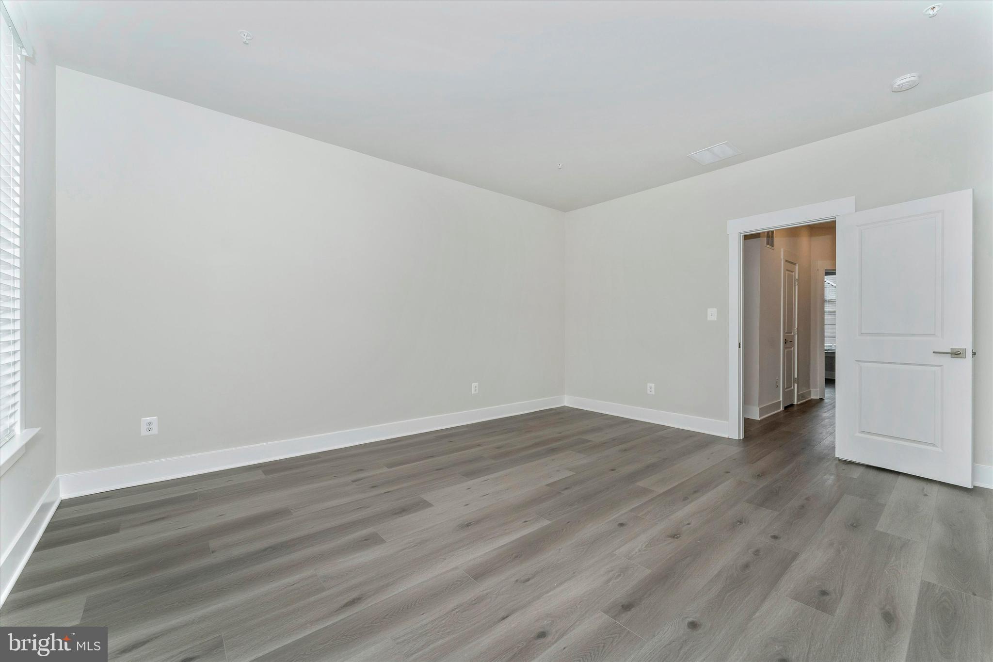2923 Osprey Way Frederick, MD 21701 - Photo 32 of 42 a view of an empty room with wooden floor and a window