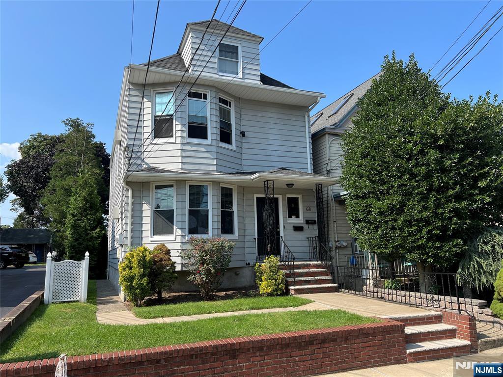 68 Liberty Street, Unit 1 Lodi, NJ 07644 - Photo 1 of 23 a front view of a house with a yard