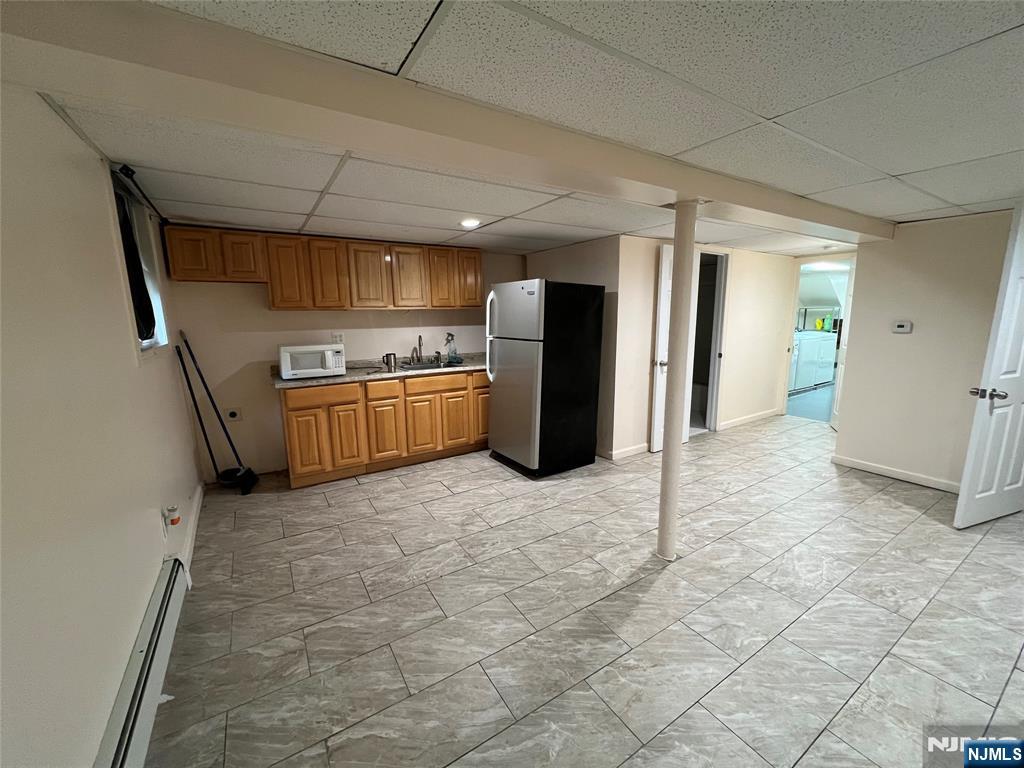 68 Liberty Street, Unit 1 Lodi, NJ 07644 - Photo 17 of 23 a view of a kitchen with refrigerator and microwave