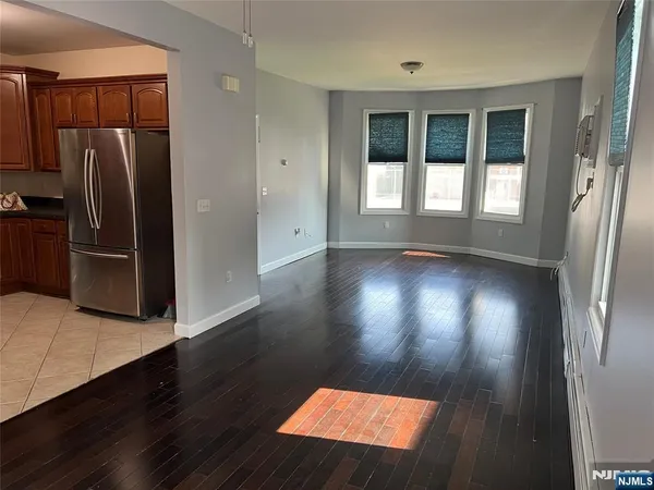 a view of a refrigerator in kitchen and wooden floor