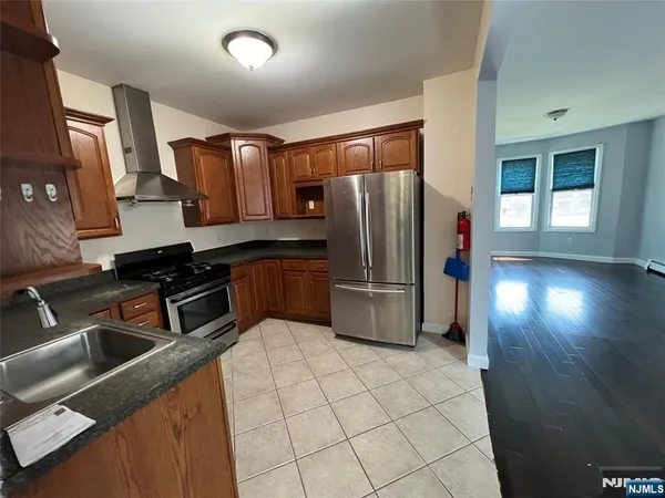 a kitchen with stainless steel appliances a refrigerator and a sink