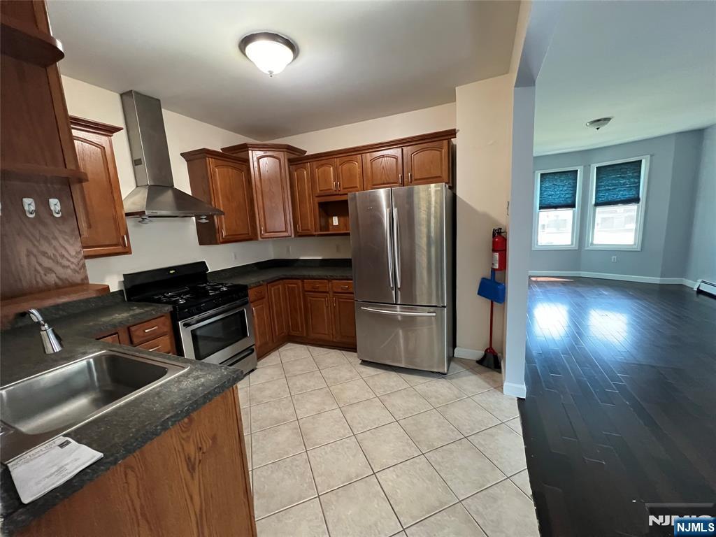 68 Liberty Street, Unit 1 Lodi, NJ 07644 - Photo 4 of 23 a kitchen with stainless steel appliances a refrigerator and a sink