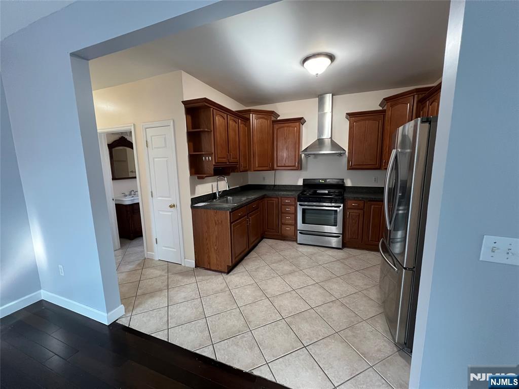 68 Liberty Street, Unit 1 Lodi, NJ 07644 - Photo 6 of 23 a kitchen with stainless steel appliances a refrigerator and a stove top oven