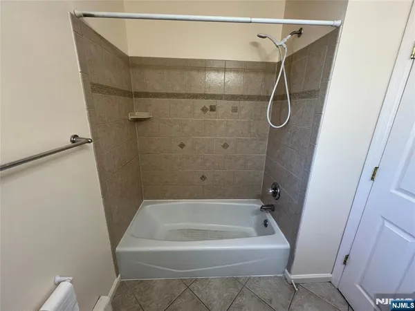 a bathroom with a bath tub and shower
