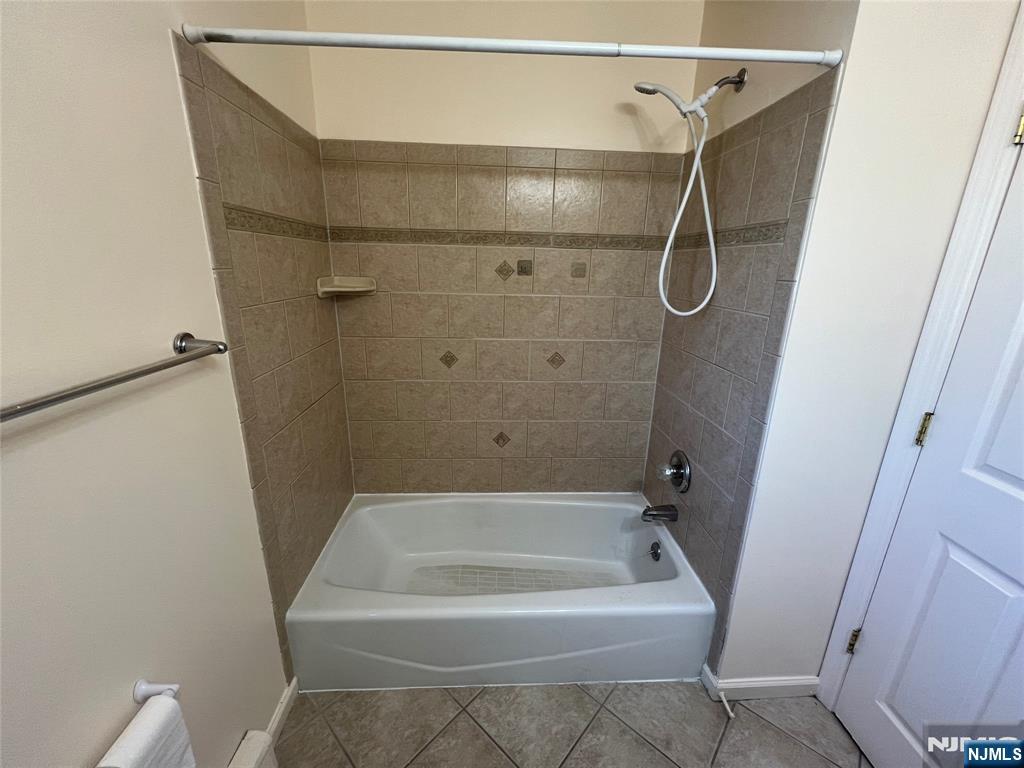 68 Liberty Street, Unit 1 Lodi, NJ 07644 - Photo 9 of 23 a bathroom with a bath tub and shower