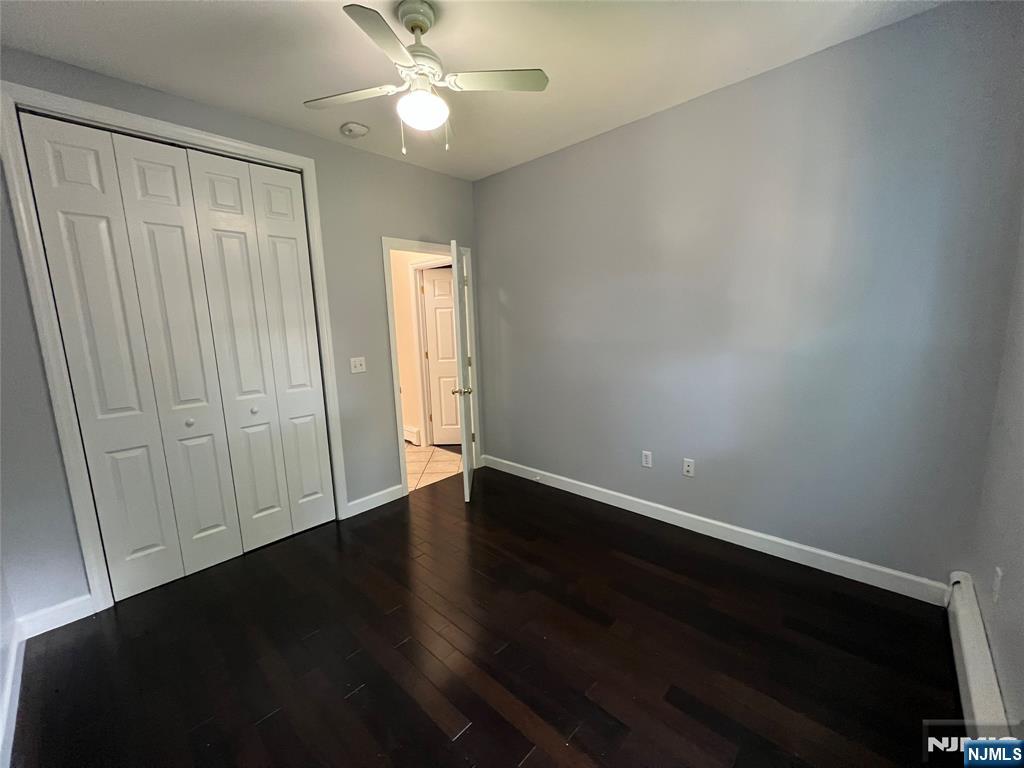 68 Liberty Street, Unit 1 Lodi, NJ 07644 - Photo 10 of 23 an empty room with wooden floor and fan