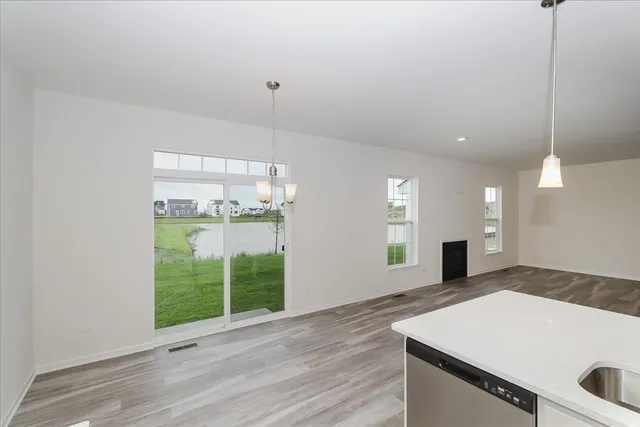 a view of a kitchen with a sink and wooden floor
