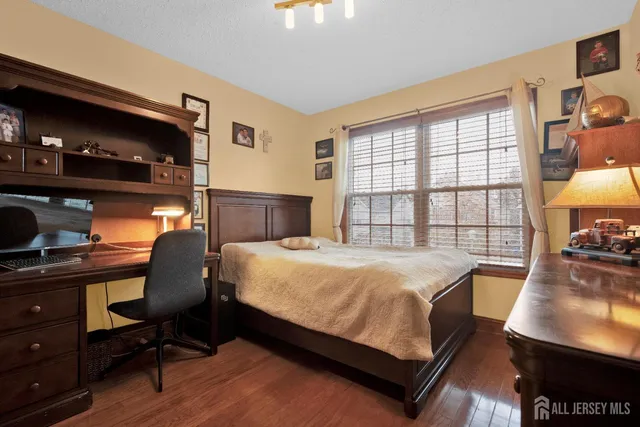 a bedroom with a bed window and table