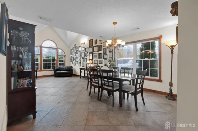 a view of a dining room with furniture and chandelier