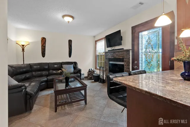 a living room with furniture and a fireplace
