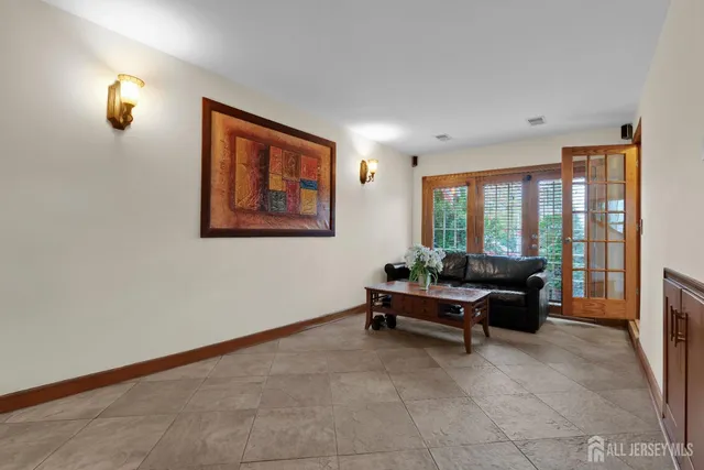 a living room with furniture and large windows