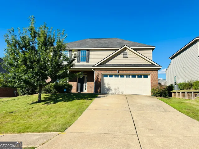 a front view of a house with a yard