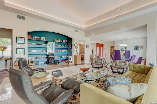a living room with fireplace furniture and a large window