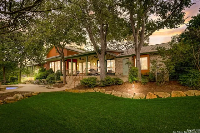 a view of a house with backyard porch and sitting area