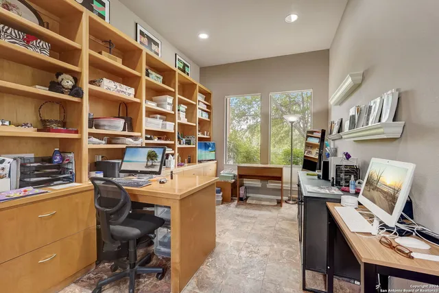 a view of a workspace with furniture and a workspace
