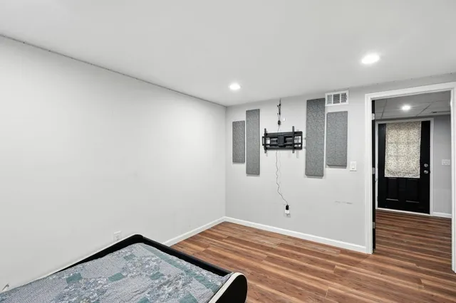 a view of a room with wooden floor and windows