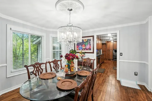 a view of a dining room with furniture wooden floor and chandelier