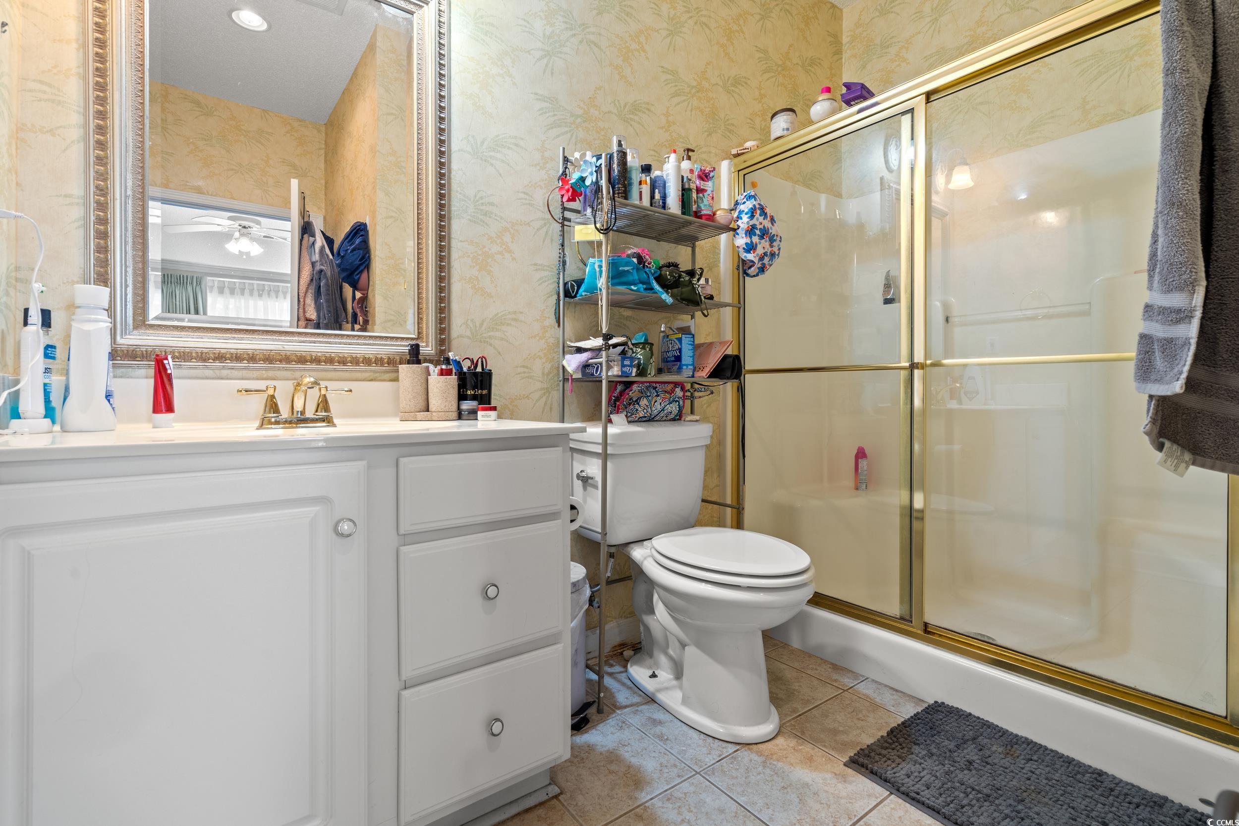 509 Shellbank Drive, Unit B Longs, SC 29568 - Photo 13 of 33 Bathroom featuring wallpapered walls, tile patterned floors, vanity, and a shower stall
