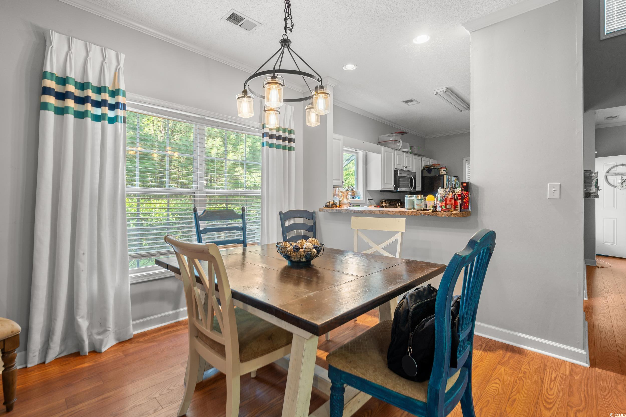 509 Shellbank Drive, Unit B Longs, SC 29568 - Photo 14 of 33 Dining space with ornamental molding, light wood-style flooring, and recessed lighting