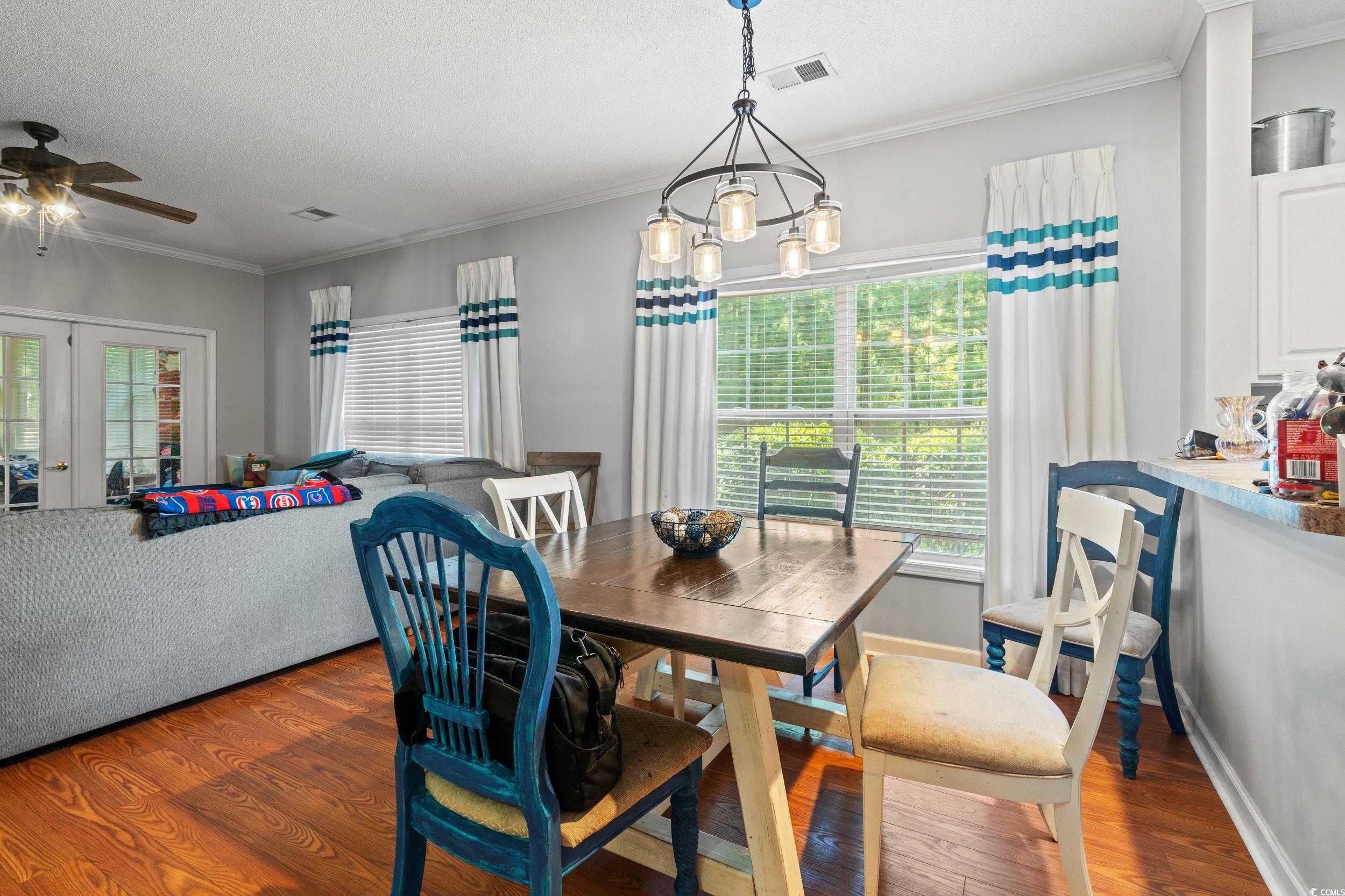 509 Shellbank Drive, Unit B Longs, SC 29568 - Photo 15 of 33 Dining space featuring a ceiling fan, wood finished floors, crown molding, and a textured ceiling