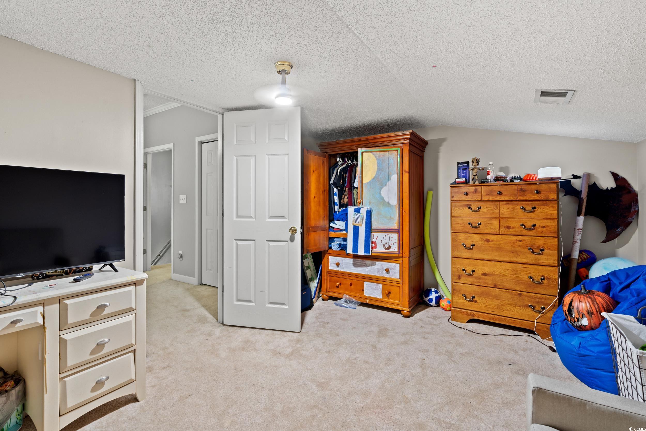 509 Shellbank Drive, Unit B Longs, SC 29568 - Photo 20 of 33 Bedroom with light carpet and a textured ceiling