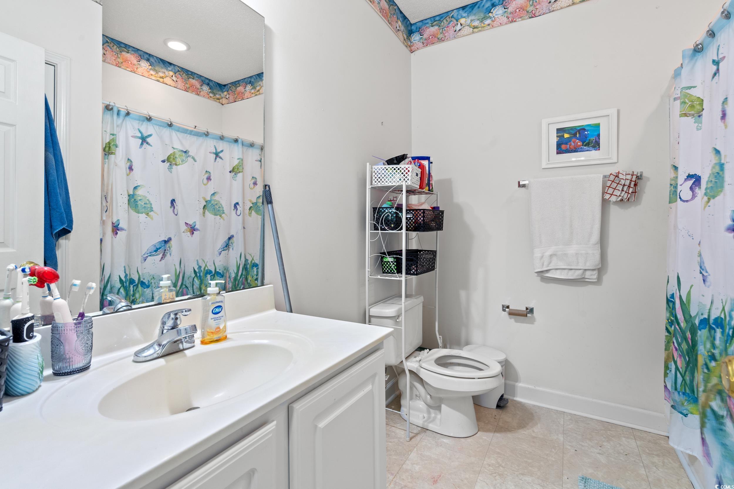 509 Shellbank Drive, Unit B Longs, SC 29568 - Photo 25 of 33 Full bath with vanity, tile patterned flooring, and a shower with shower curtain
