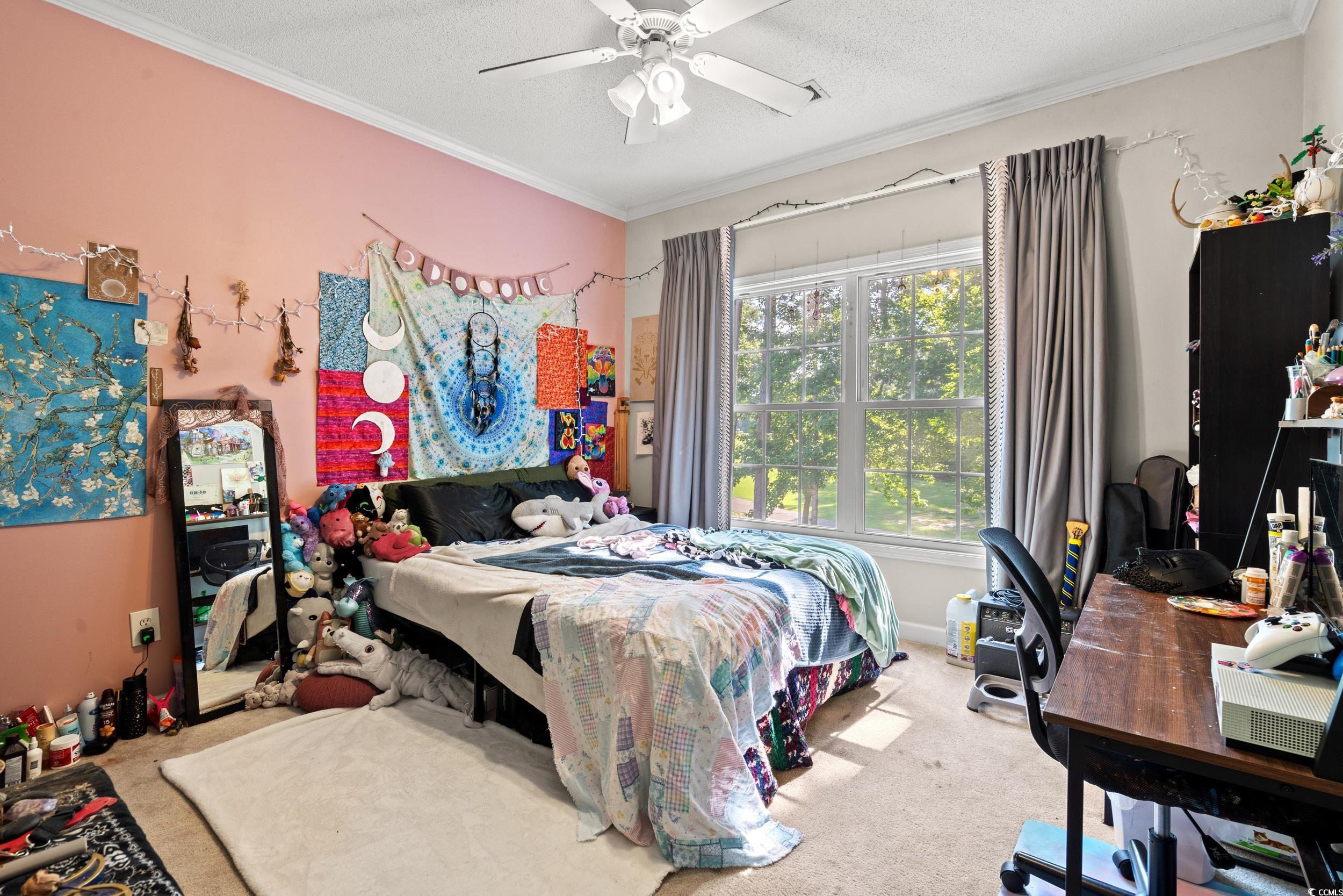 509 Shellbank Drive, Unit B Longs, SC 29568 - Photo 26 of 33 Bedroom featuring carpet flooring, crown molding, an office area, a ceiling fan, and a textured ceiling