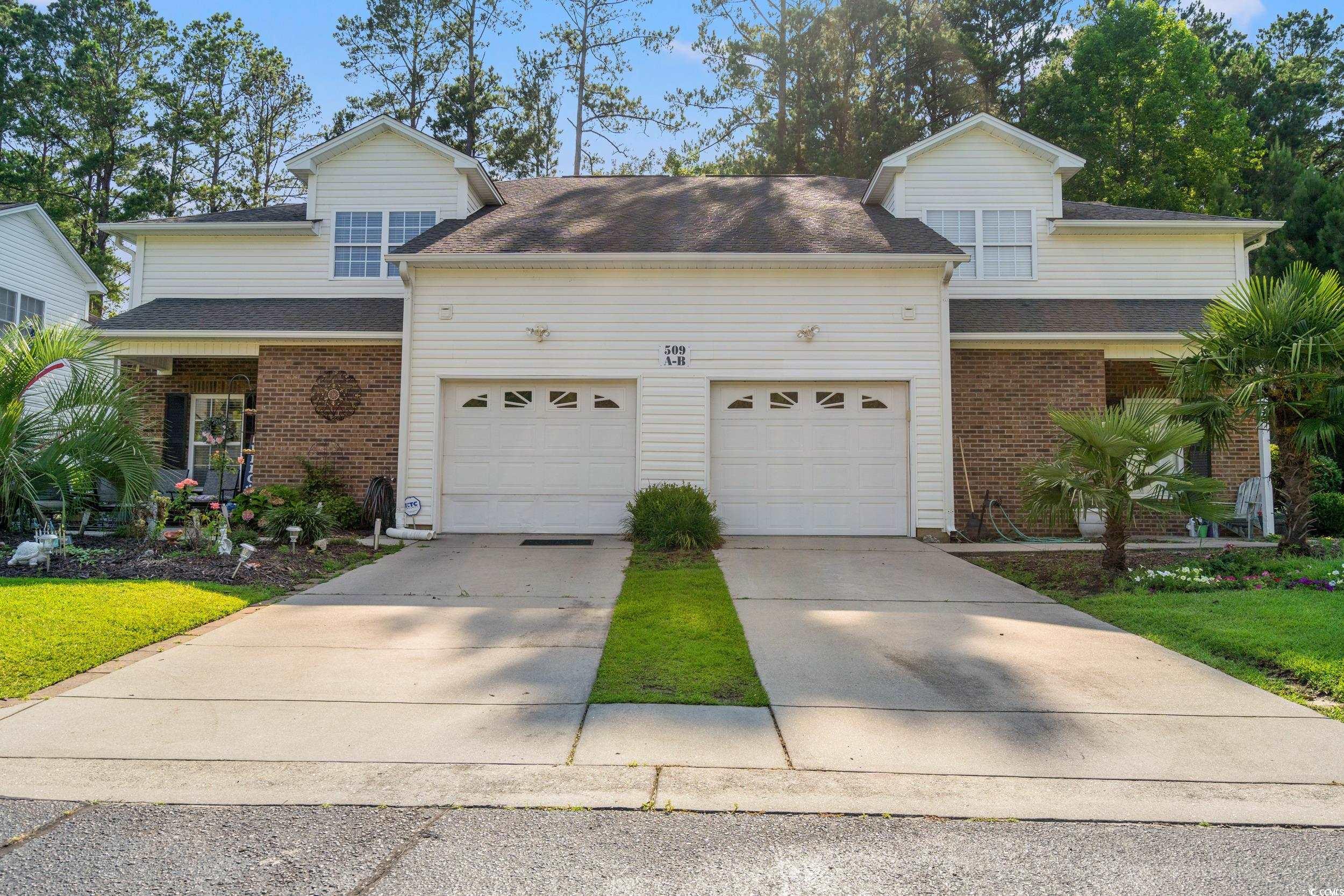 509 Shellbank Drive, Unit B Longs, SC 29568 - Photo 32 of 33 Traditional-style home featuring an attached garage, driveway, and brick siding