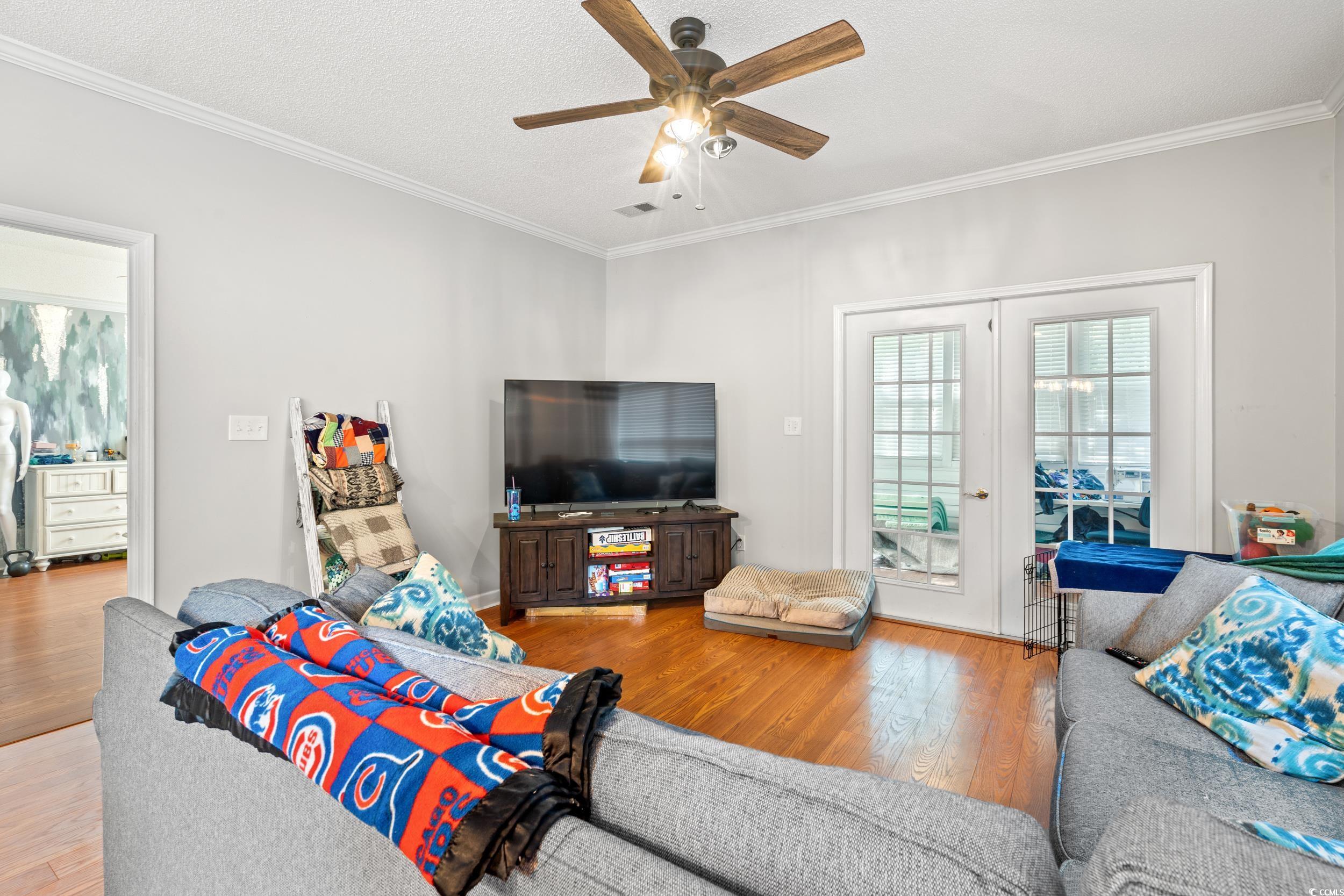 509 Shellbank Drive, Unit B Longs, SC 29568 - Photo 4 of 33 Living room featuring hardwood / wood-style flooring, crown molding, and ceiling fan