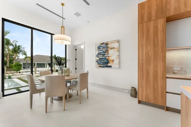 a living room with furniture a flat screen tv and a large window