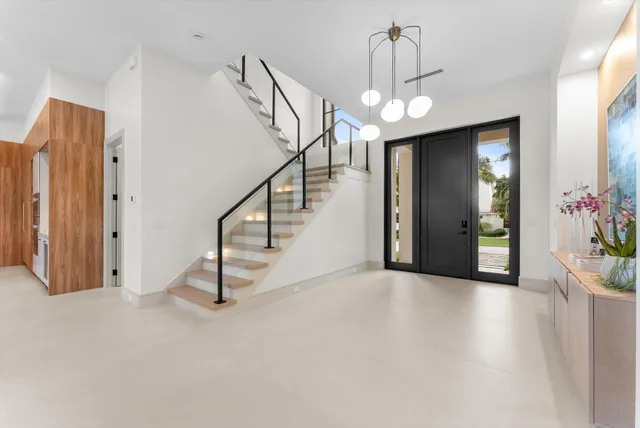 a view of a kitchen with an entryway and an empty room