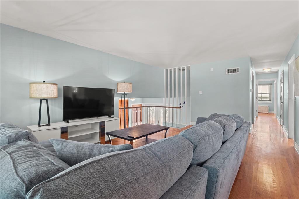 6515 Dimarco Road Tampa, FL 33634 - Photo 6 of 66 a living room with furniture and a flat screen tv