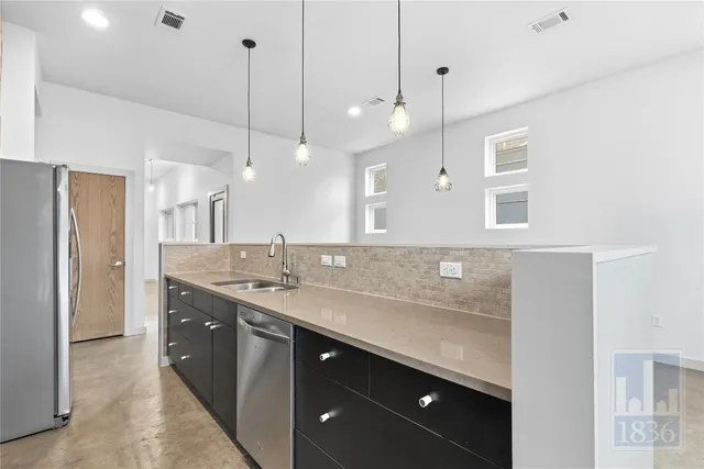 a bathroom with a sink a vanity a large mirror and a shower