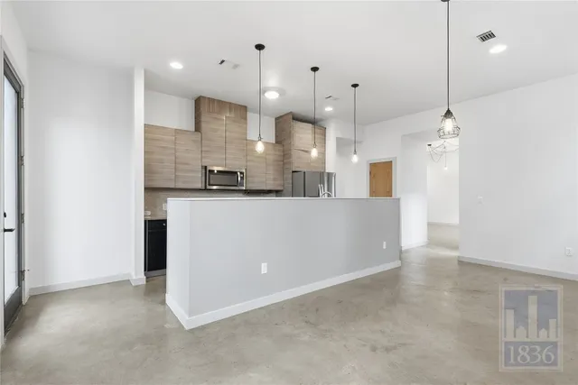 a view of a kitchen with stainless steel appliances granite countertop cabinets