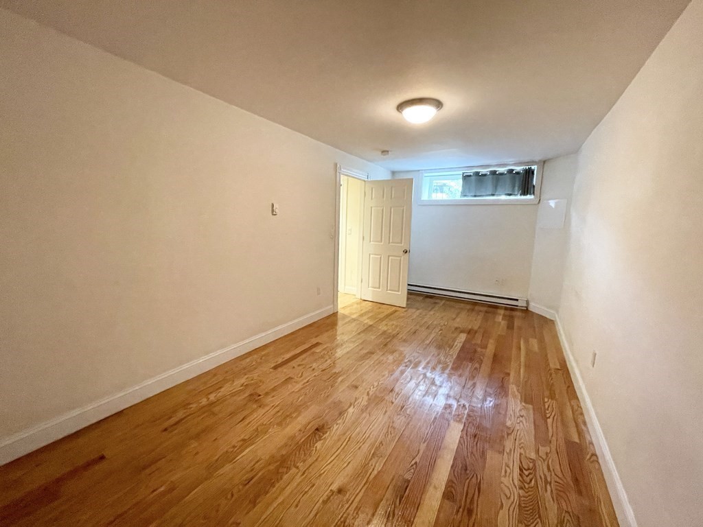 98 L Street, Unit STREET Boston, MA 02127 - Photo 13 of 19 a view of empty room with wooden floor
